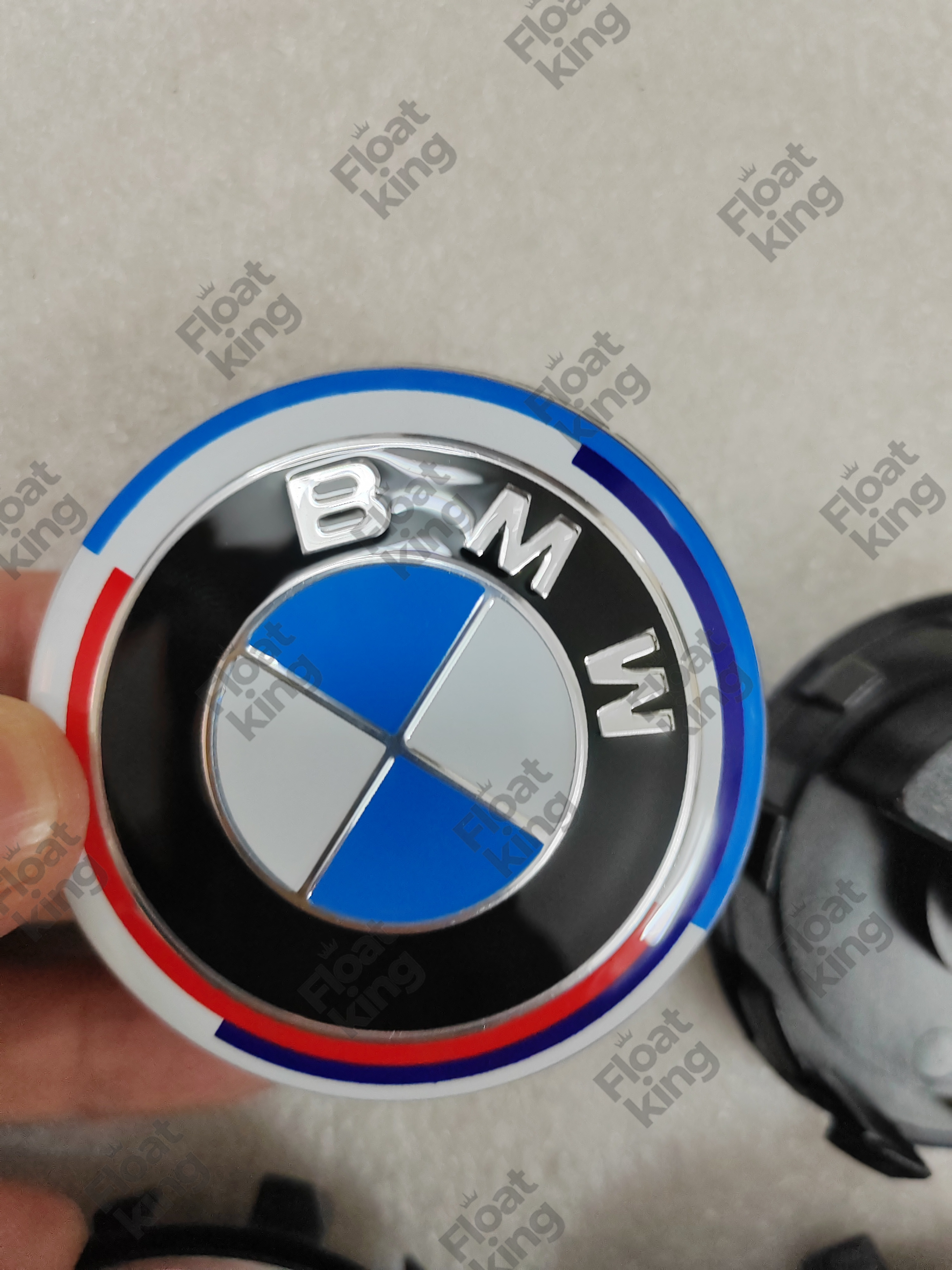 BMW 50th Anniversary Floating Center Caps - hands holding the cap