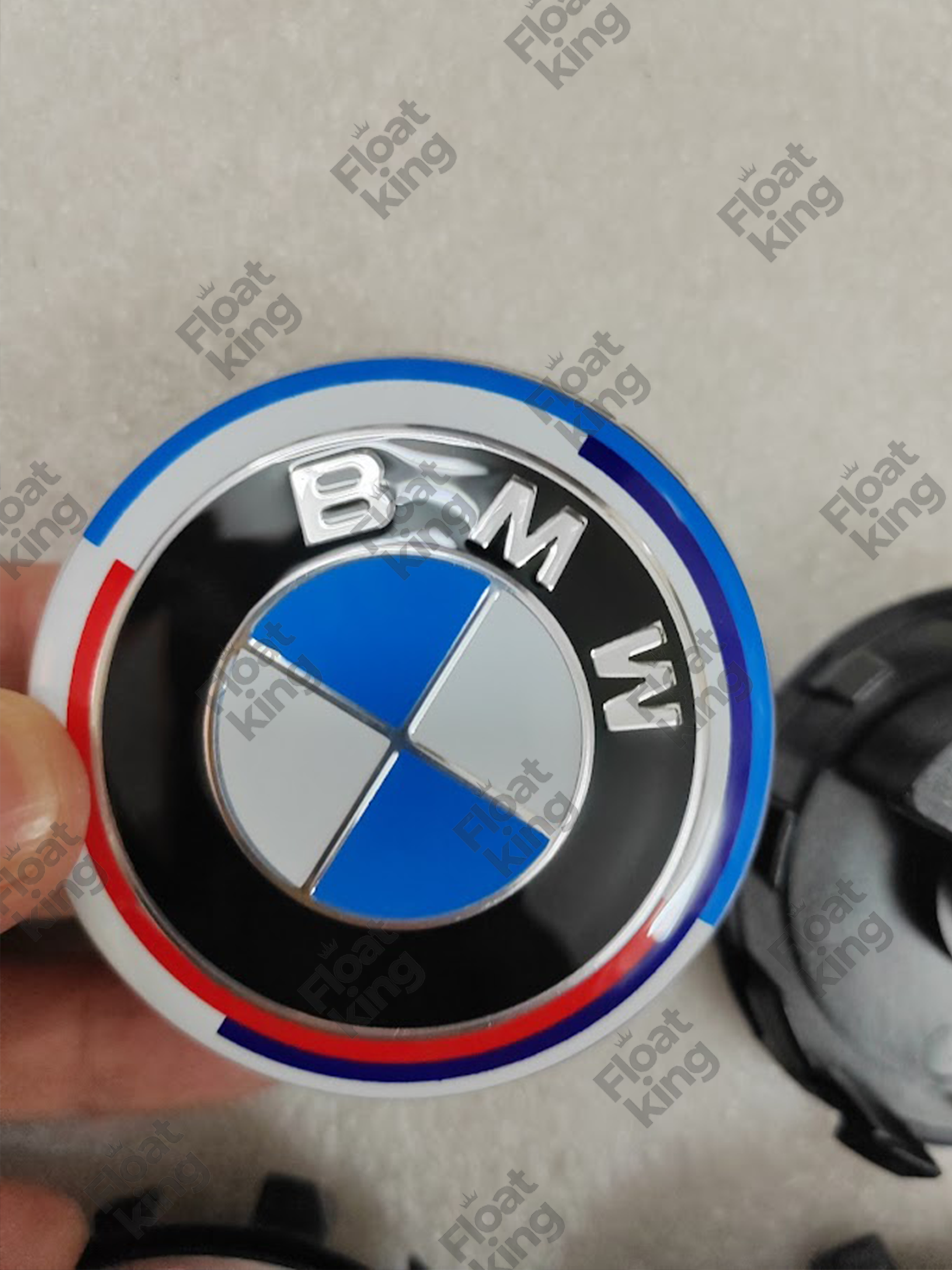 BMW 50th Anniversary Floating Center Caps - hands holding the cap